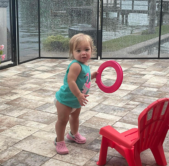 Little child playing by the poolside